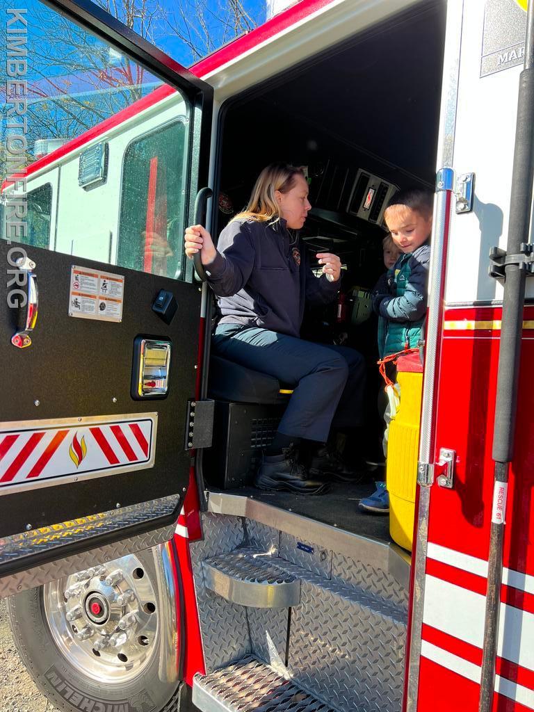 Samantha Gable shows children the inside of the fire truck